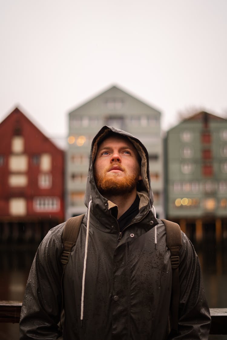 Portrait Of A Man In A Raincoat Looking Up 