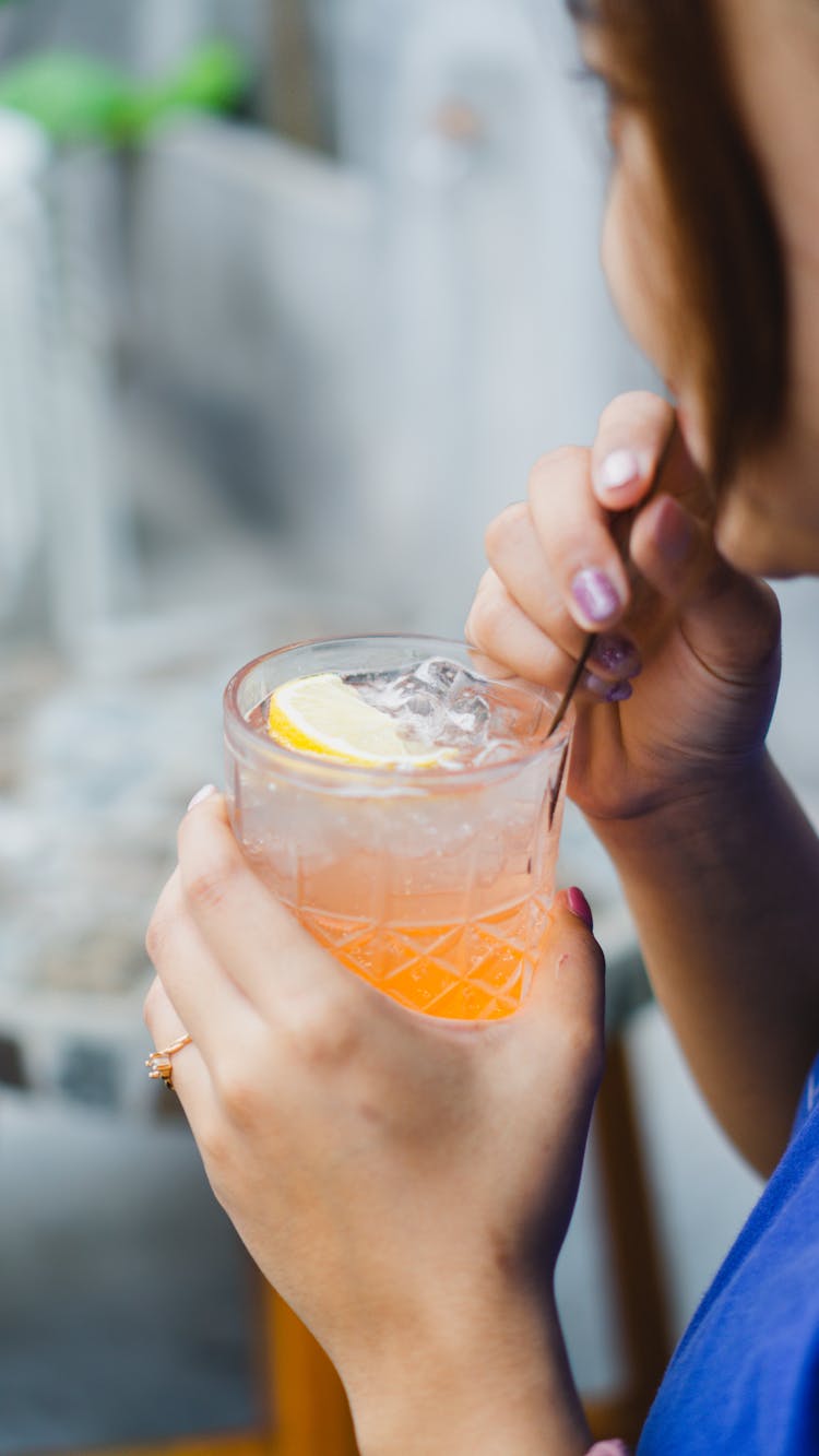 A Woman Drinking A Cocktail