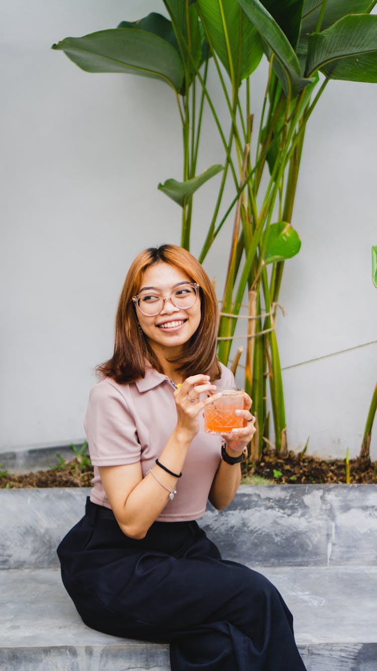 A Woman Holding A Cocktail