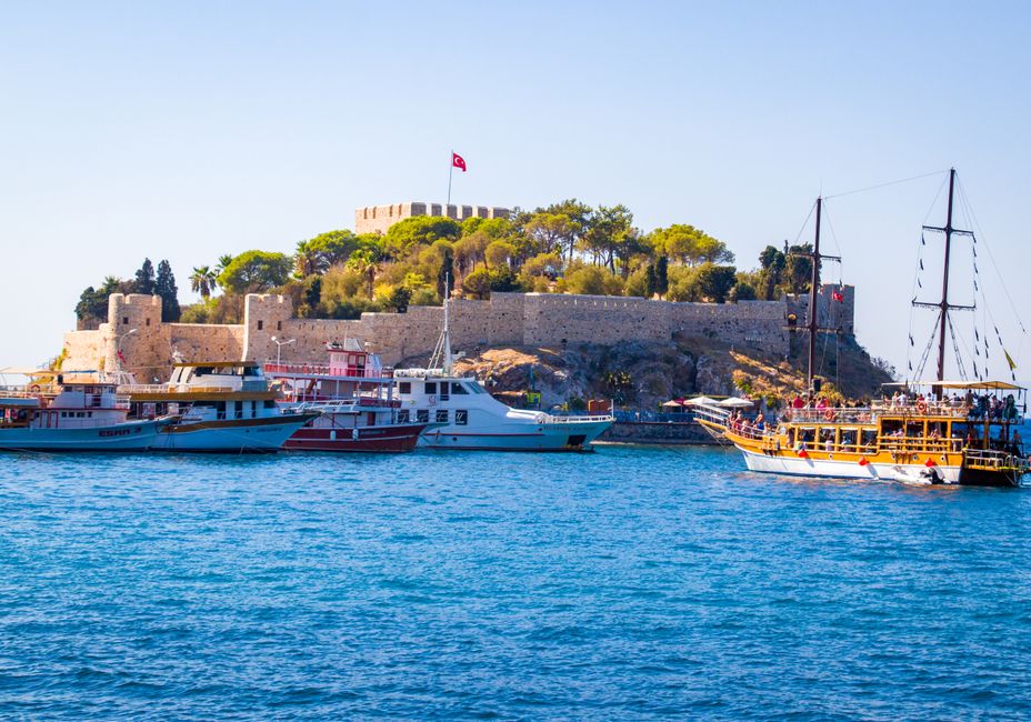 Best Full Day All Inclusive Boat Ride and Foam Party Review: My Unforgettable Turkish Riviera Adventure Review 2026 - Scenic view of a coastal castle with boats in Kusadasi, Turkey on a clear day.