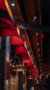 Urban street scene at night showcasing vibrant red facades and modern lighting.
