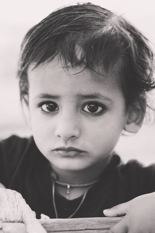Free Heartfelt black and white portrait of a young Indian child with expressive eyes. Stock Photo