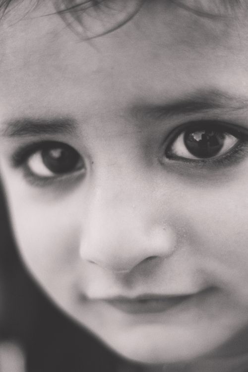 Free Black and white close-up portrait of a young girl with expressive eyes. Stock Photo