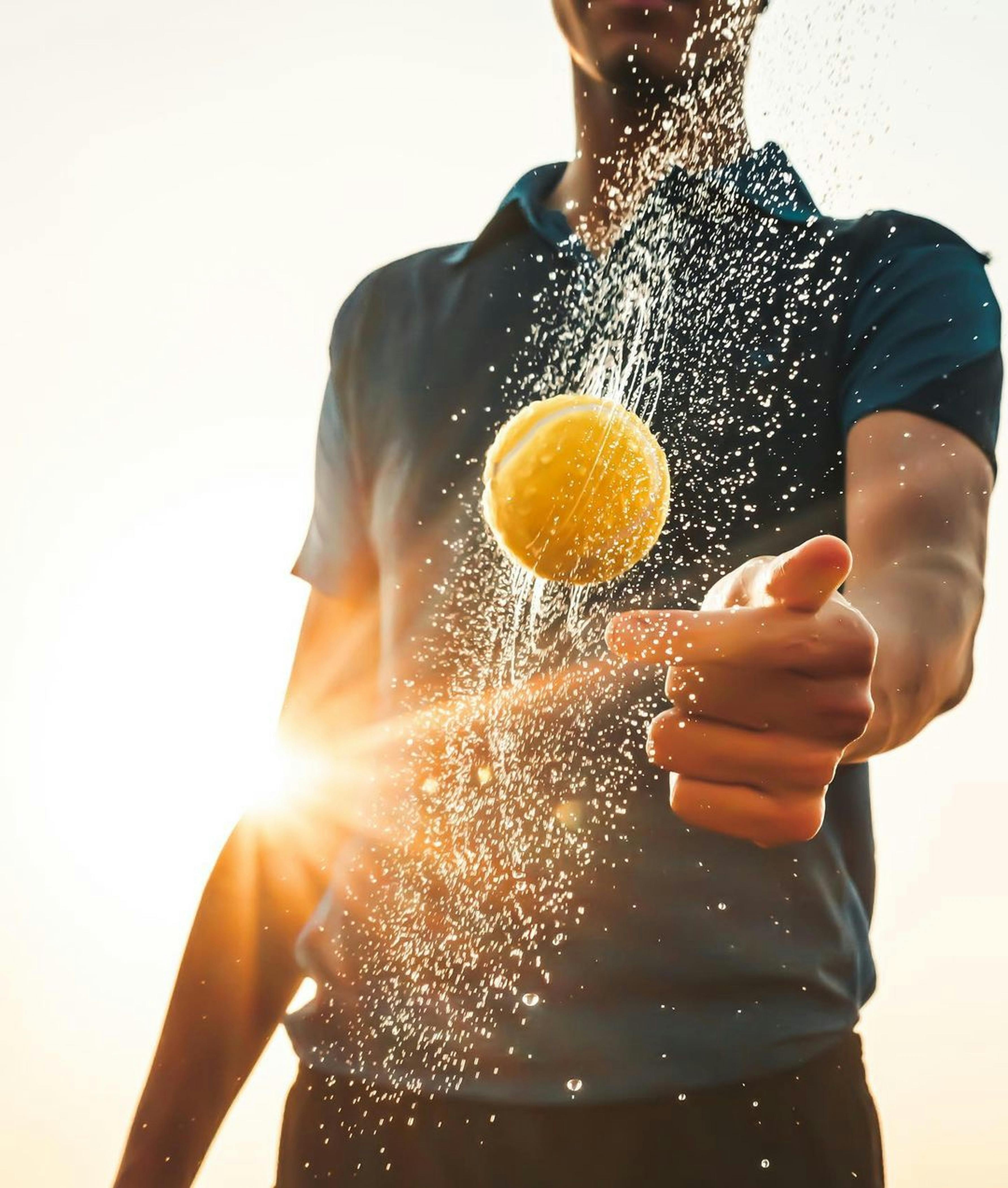 A person holding a glass of water in front of a window · Free Stock Photo