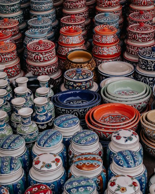 Free Vibrant handmade pottery displayed in a market setting, showcasing intricate patterns and rich colors. Stock Photo