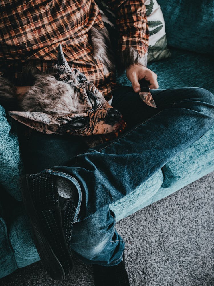 Man Holding A Realistic Wolf Mask 