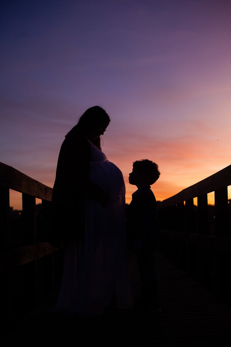 Silhouette Of Mother And Child In A Bride