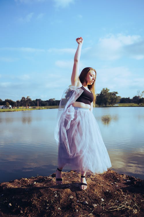 Woman Posing in a Tulle Dress Near Water 