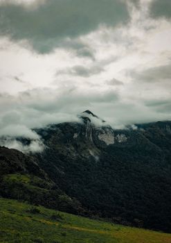 Scenic view of lush green hills and clouds over a mountain in Maidadi, Karnataka.