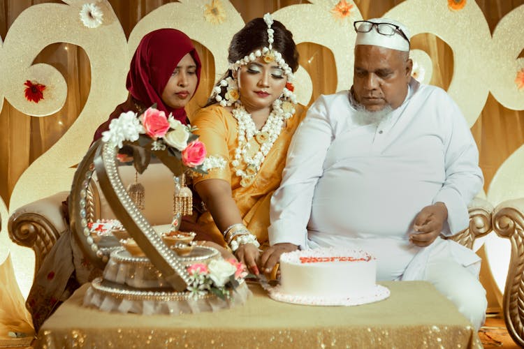 Sitting People Looking At A Cake