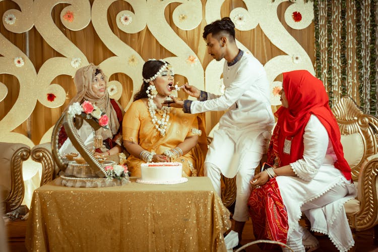 Man Feeding Bride Piece Of Cake