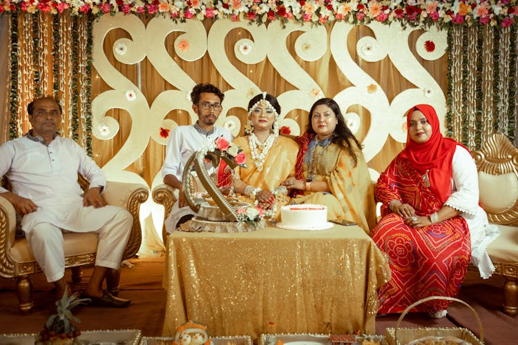 Bride And Groom With Parents On A Traditional Wedding 