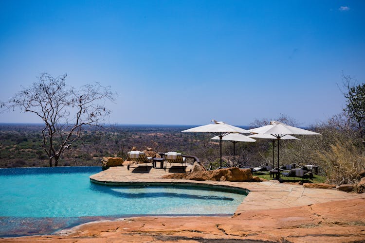 Photograph Of Umbrellas Near A Swimming Pool