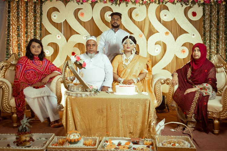 Bride In A Yellow Sari Posing With The Family On The Wedding 