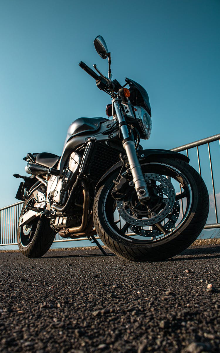 A Low Angle Shot Of A Motorcycle Parked On The Street