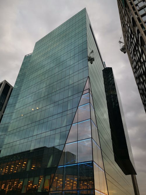 Free Low Angle Photography of a Glass Building Stock Photo