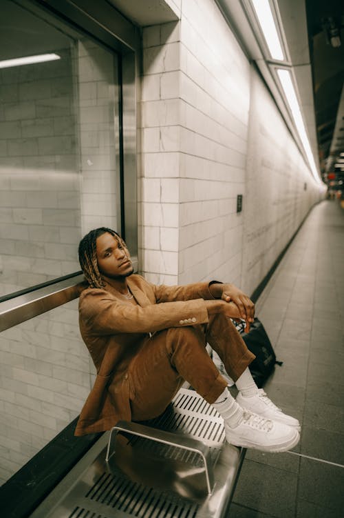 Young Fashionable Man Sitting on a Platform 