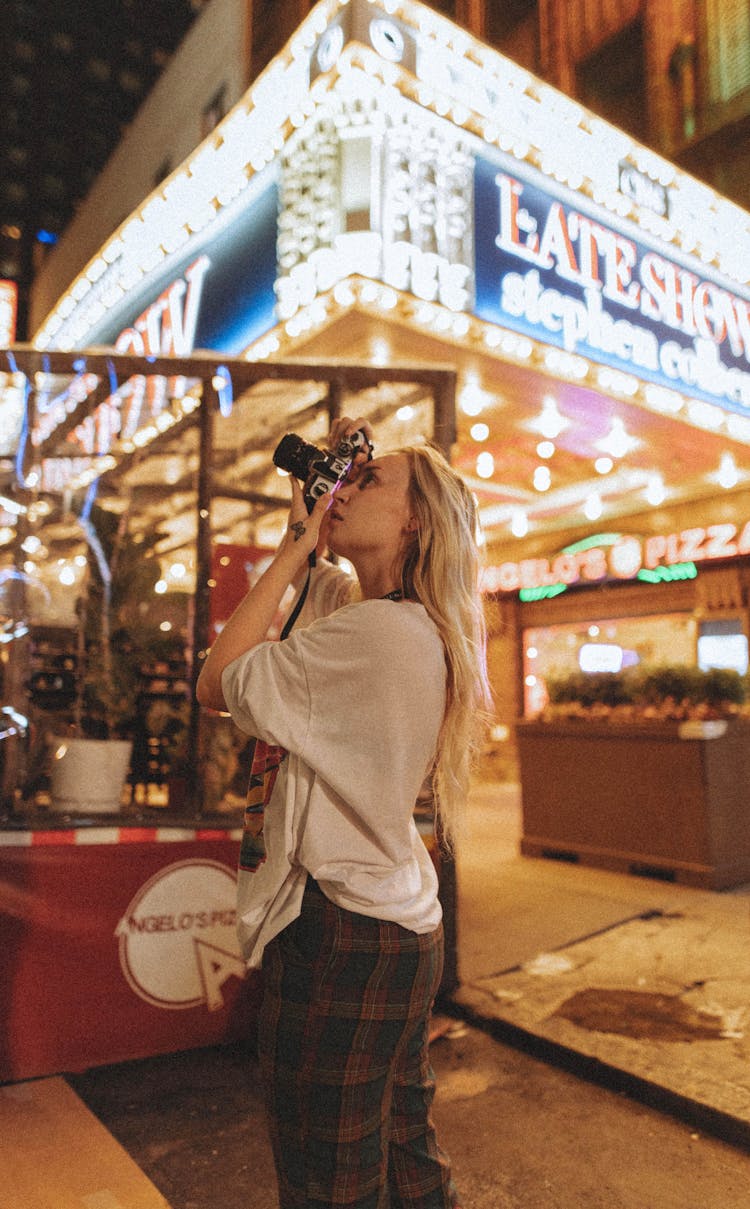 Woman Taking A Photo On Street