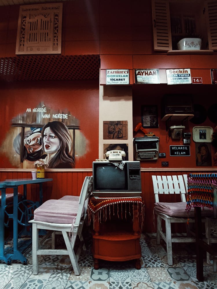 Old TV Between Tables In Restaurant