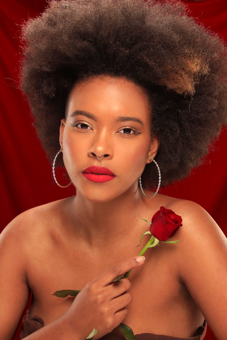 A Portrait Of A Woman Holding A Rose