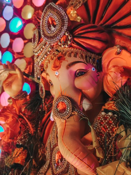 Free Close-up of a beautifully adorned Ganesh statue with intricate carvings and vibrant colors, symbolizing spirituality and tradition. Stock Photo