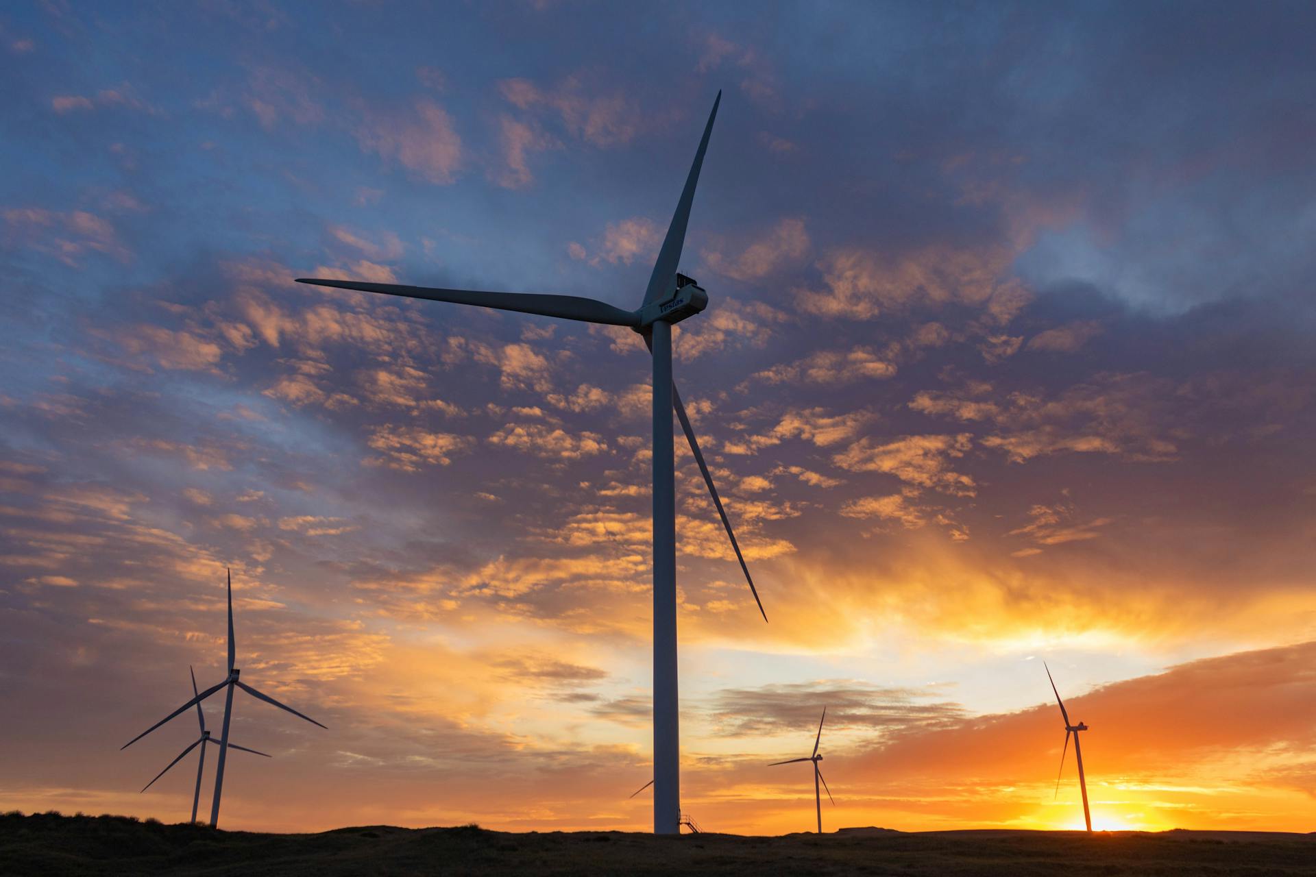 Beautiful sunset with wind turbines in Necochea, reflecting sustainable energy in Argentina.