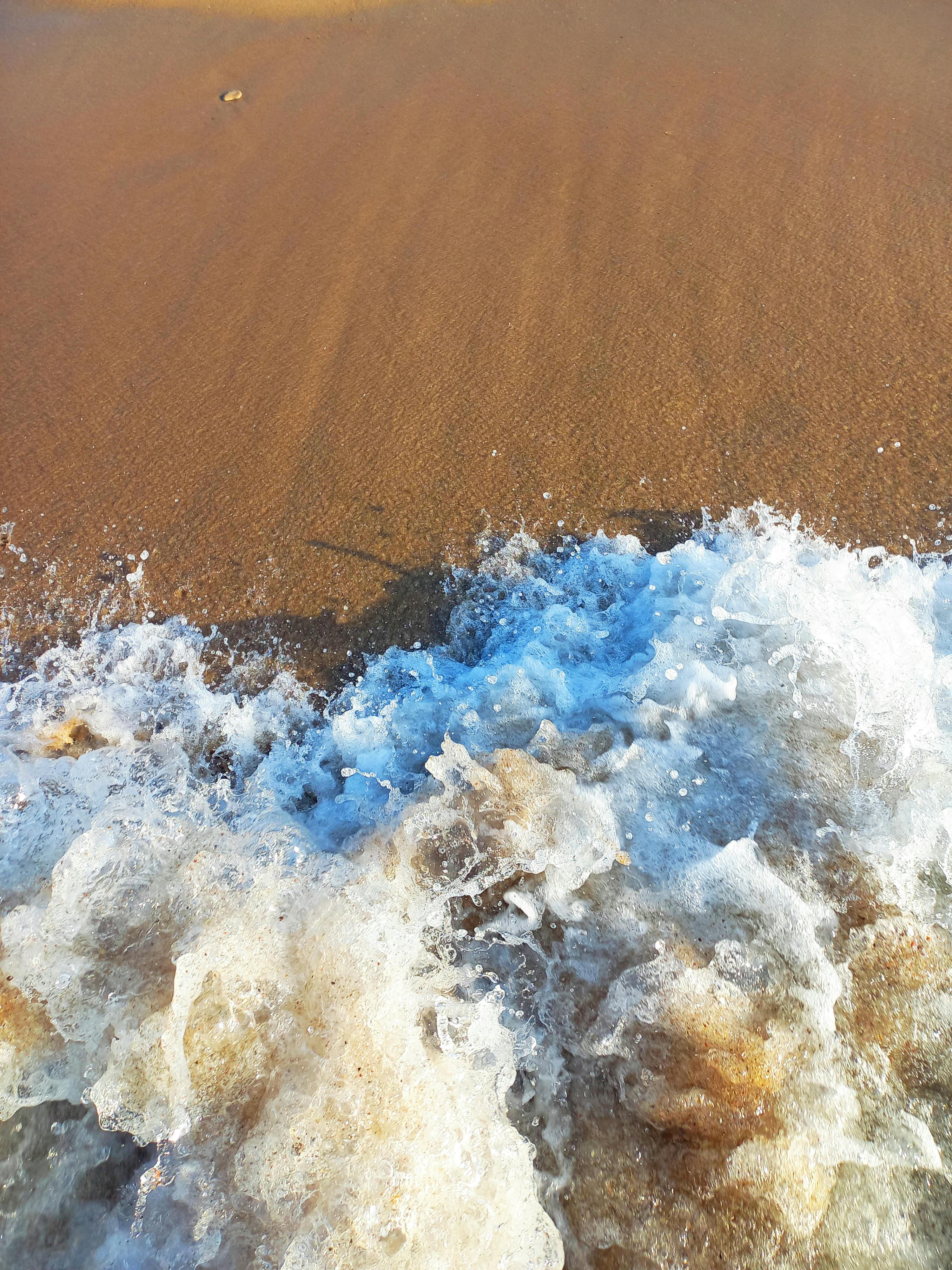 Close-Up Shot of Crashing Sea Waves on Beach Sand · Free Stock Photo