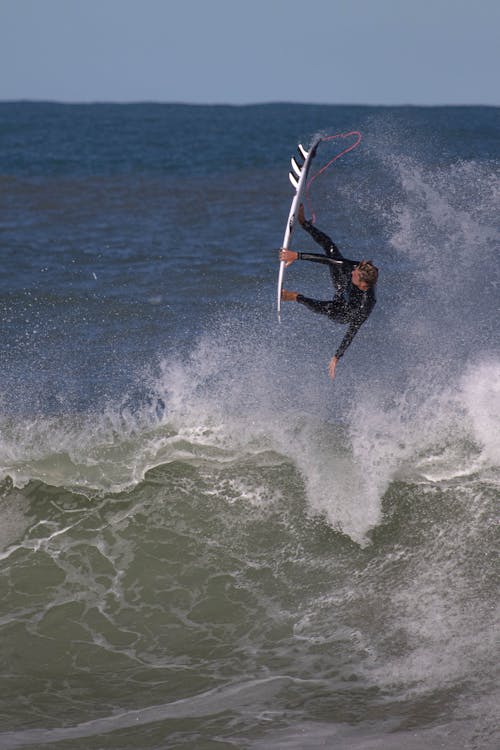 A Man Surfing on Sea Waves