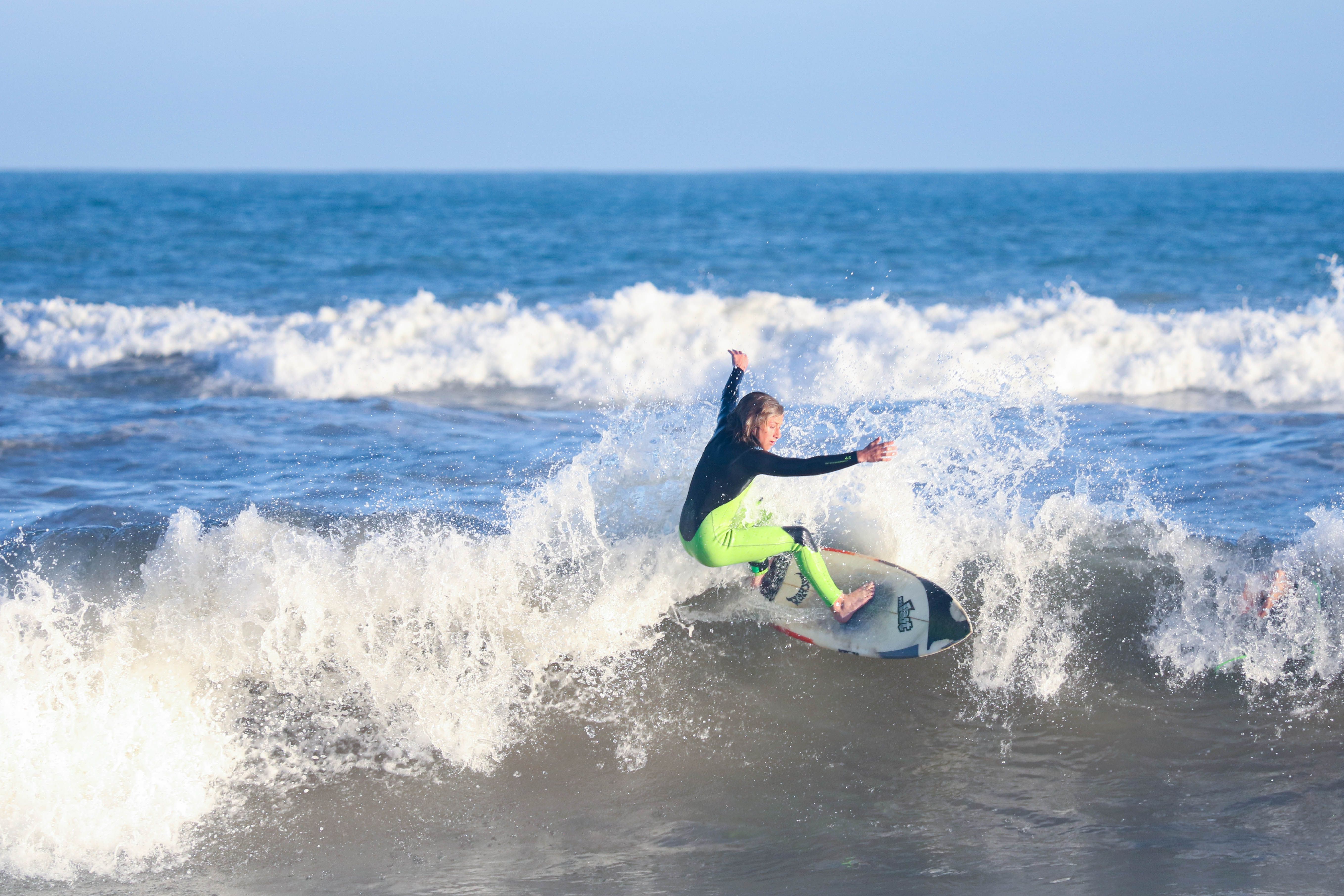 Surfer skillfully rides a wave in the ocean