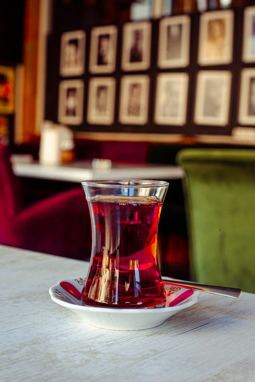 Free A warm café ambiance with a glass of red tea on a table, captured in a comfortable setting. Stock Photo