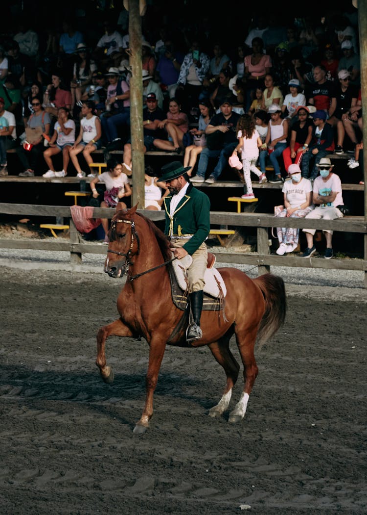 People Watching The Man Riding A Horse 