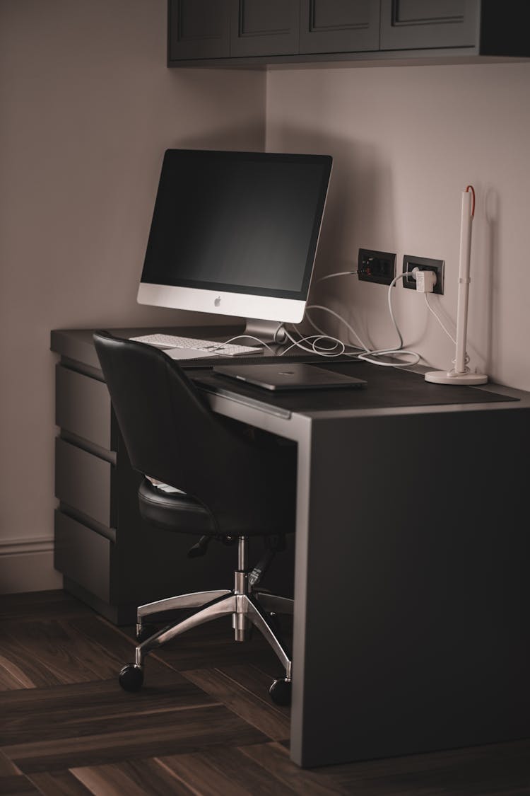 A Desktop Computer On A Black Wooden Table