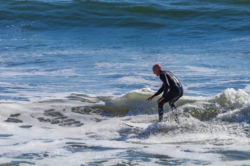 Photo of a Man Surfing Sea Wave
