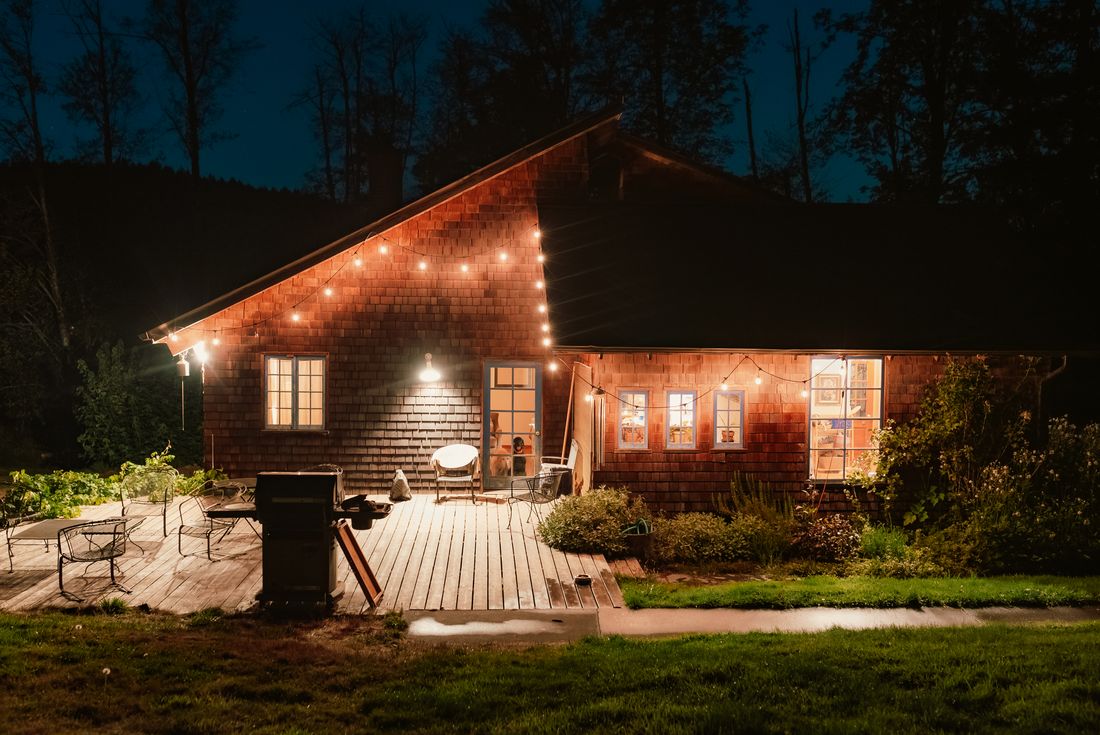 A charming wooden cabin with string lights creates a warm