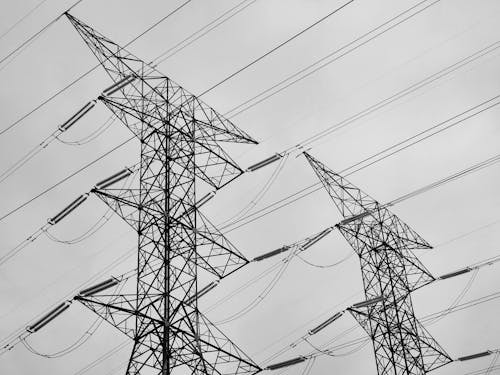 Grayscale Photo of Electric Towers