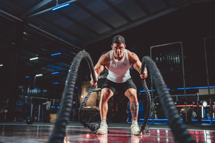 A Man Working Out At The Gym