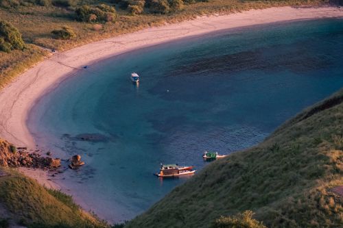 Free Aerial view of a serene beach with boats in Badjo, Nusa Tenggara, Indonesia. Stock Photo