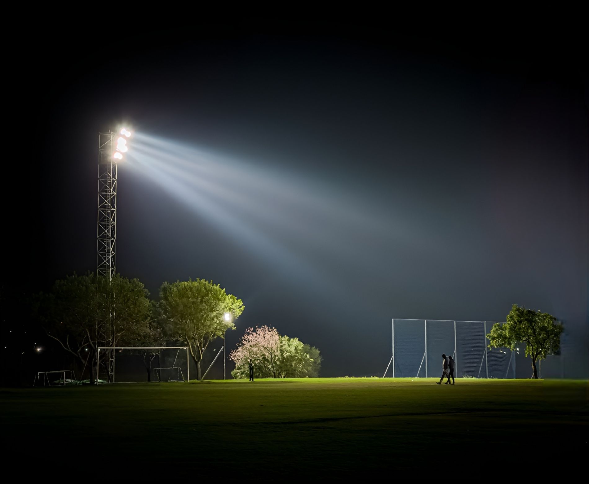 Floodlit football field at night