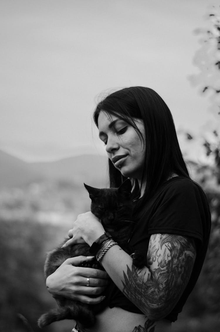 A Woman Carrying Her Cat 