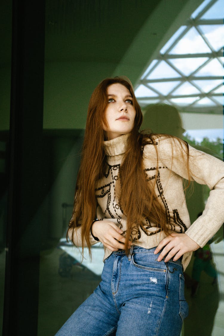 Woman Posing In Jeans And Turtleneck Sweater