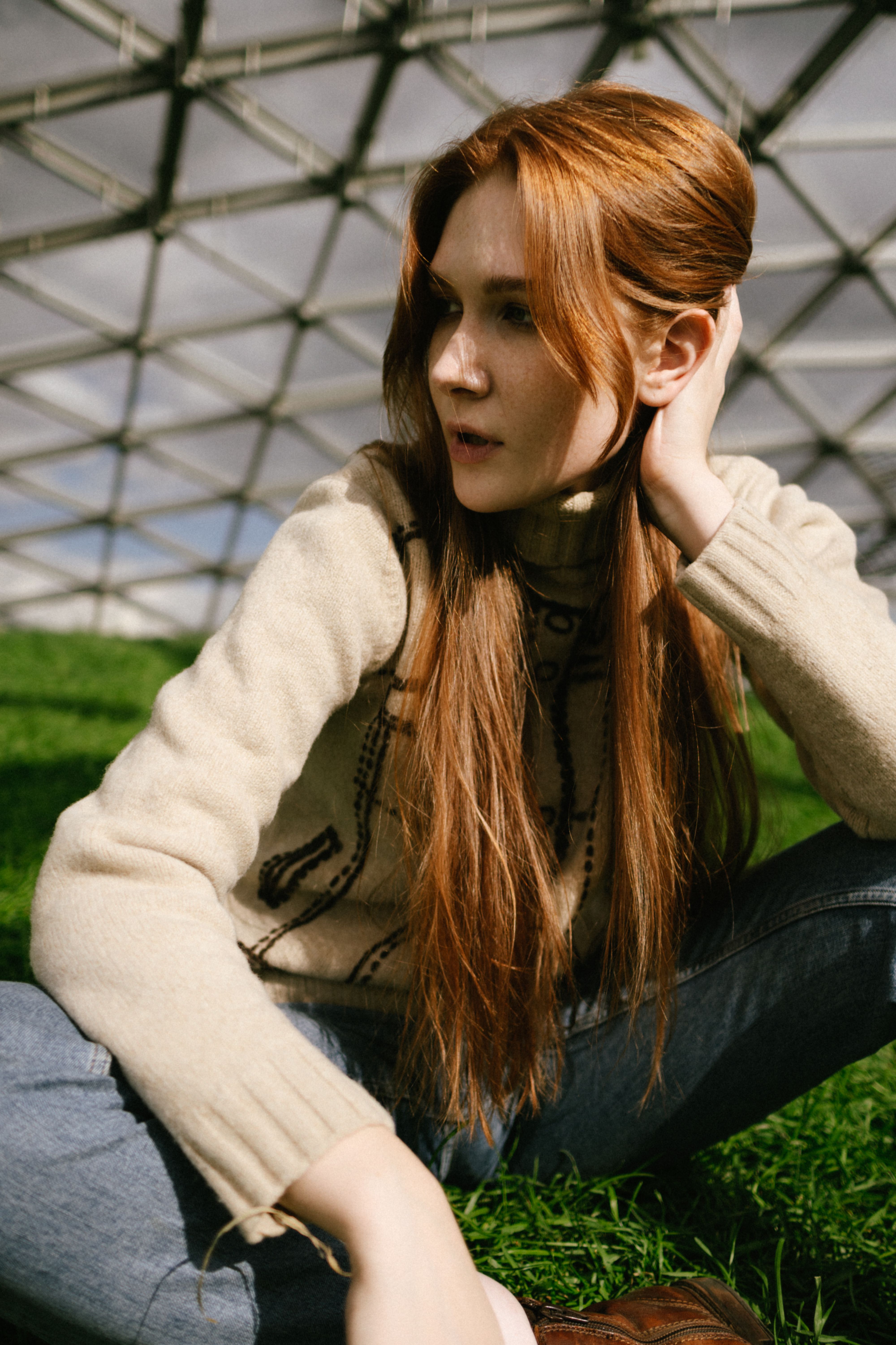 Woman in Brown Sweater Sitting on Green Grass Field · Free Stock Photo