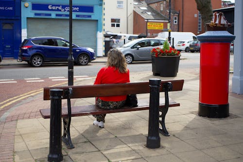 Photo of Woman Sitting on Bench
