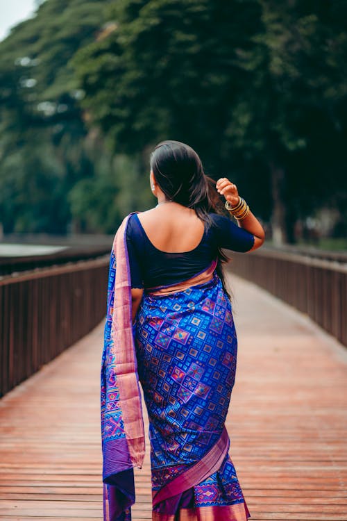 Back View of a Woman in Blue Traditional Clothing
