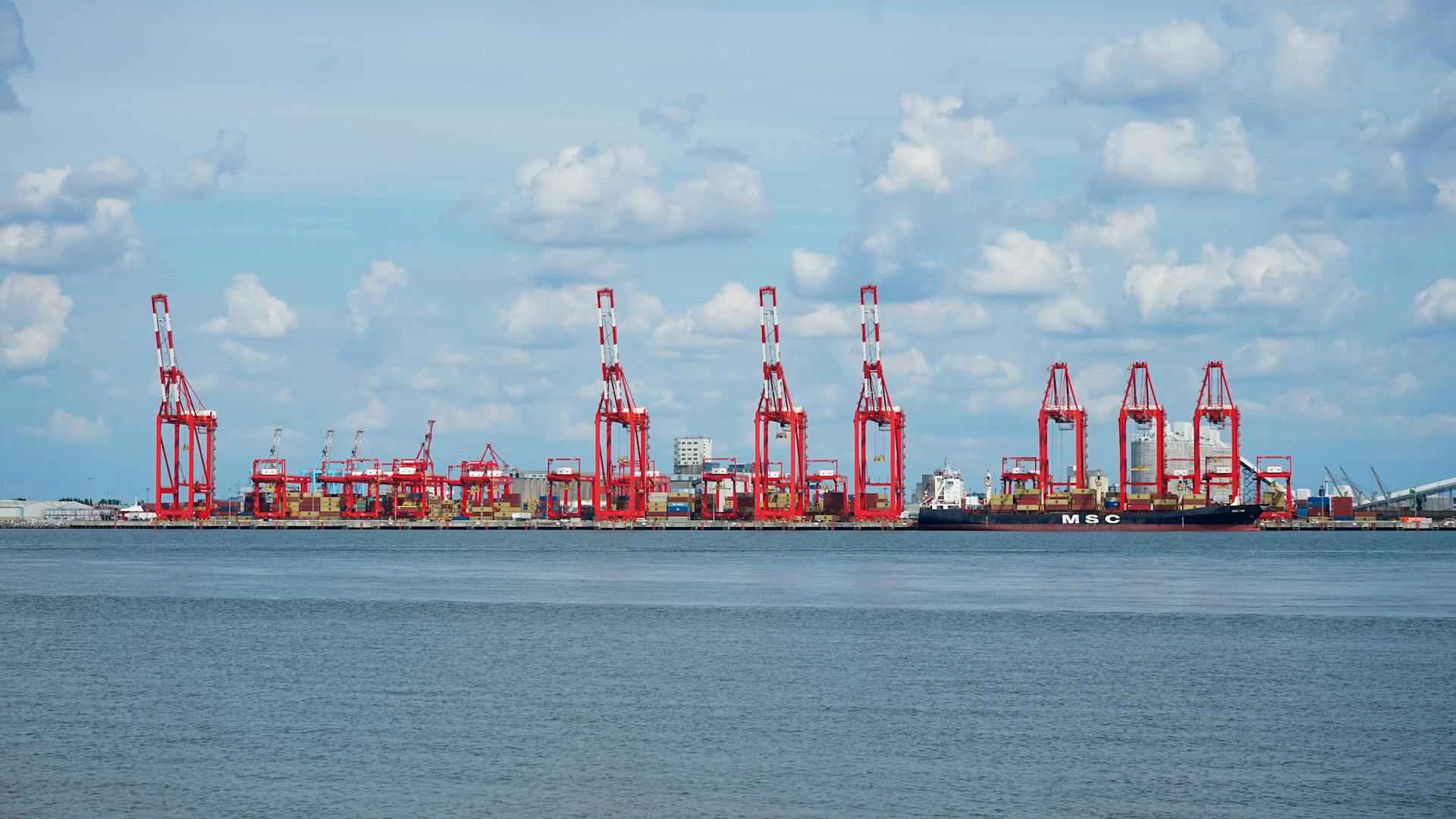 Shipping cranes at Liverpool harbor on a clear day.
