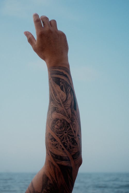 A Person With an Arm Tattoo