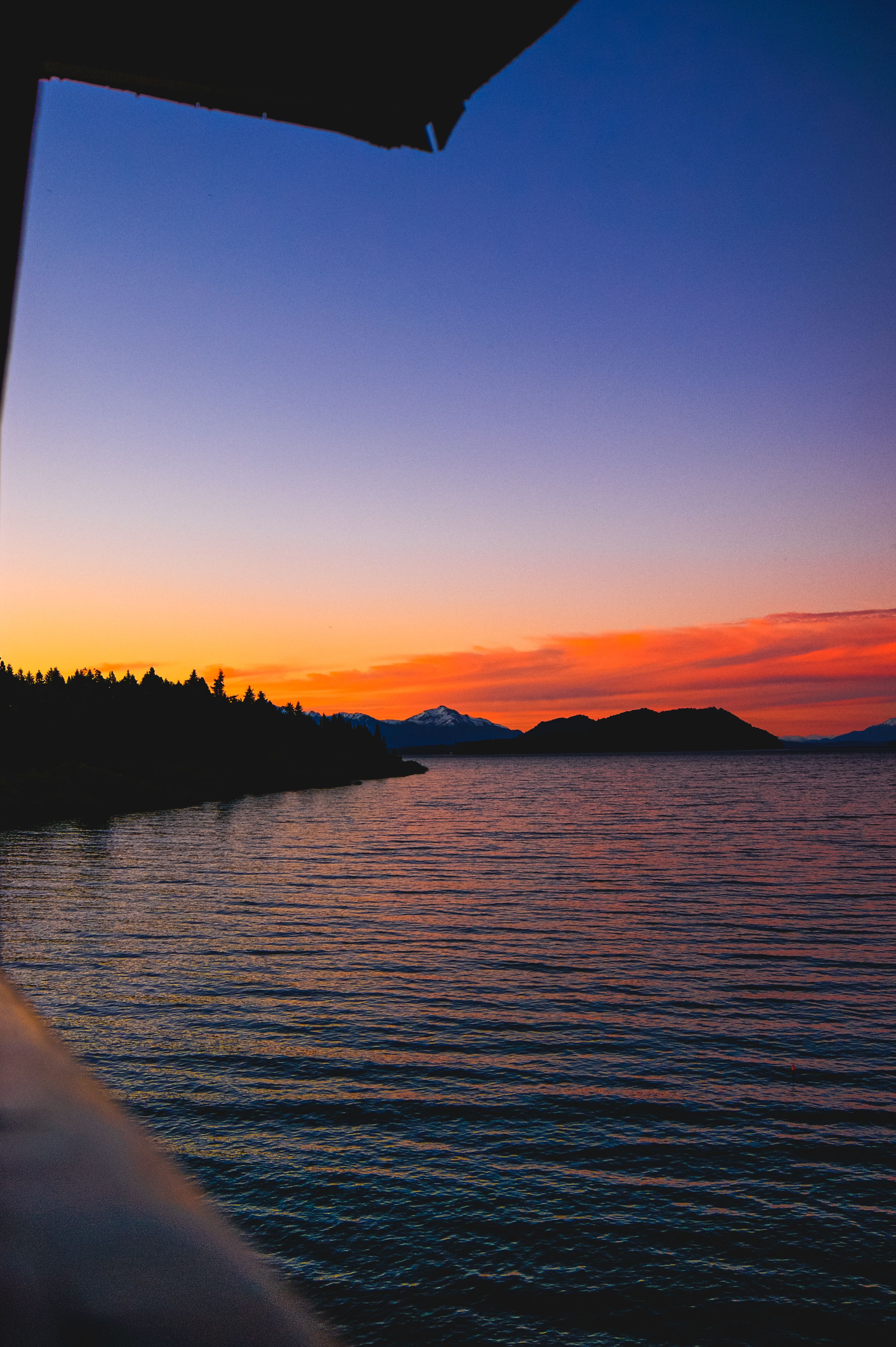 Silhouette of Mountain Near Body of Water during Sunset · Free Stock Photo