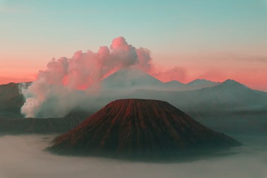Breathtaking sunrise over Mount Bromo with mist and clouds in East Java.