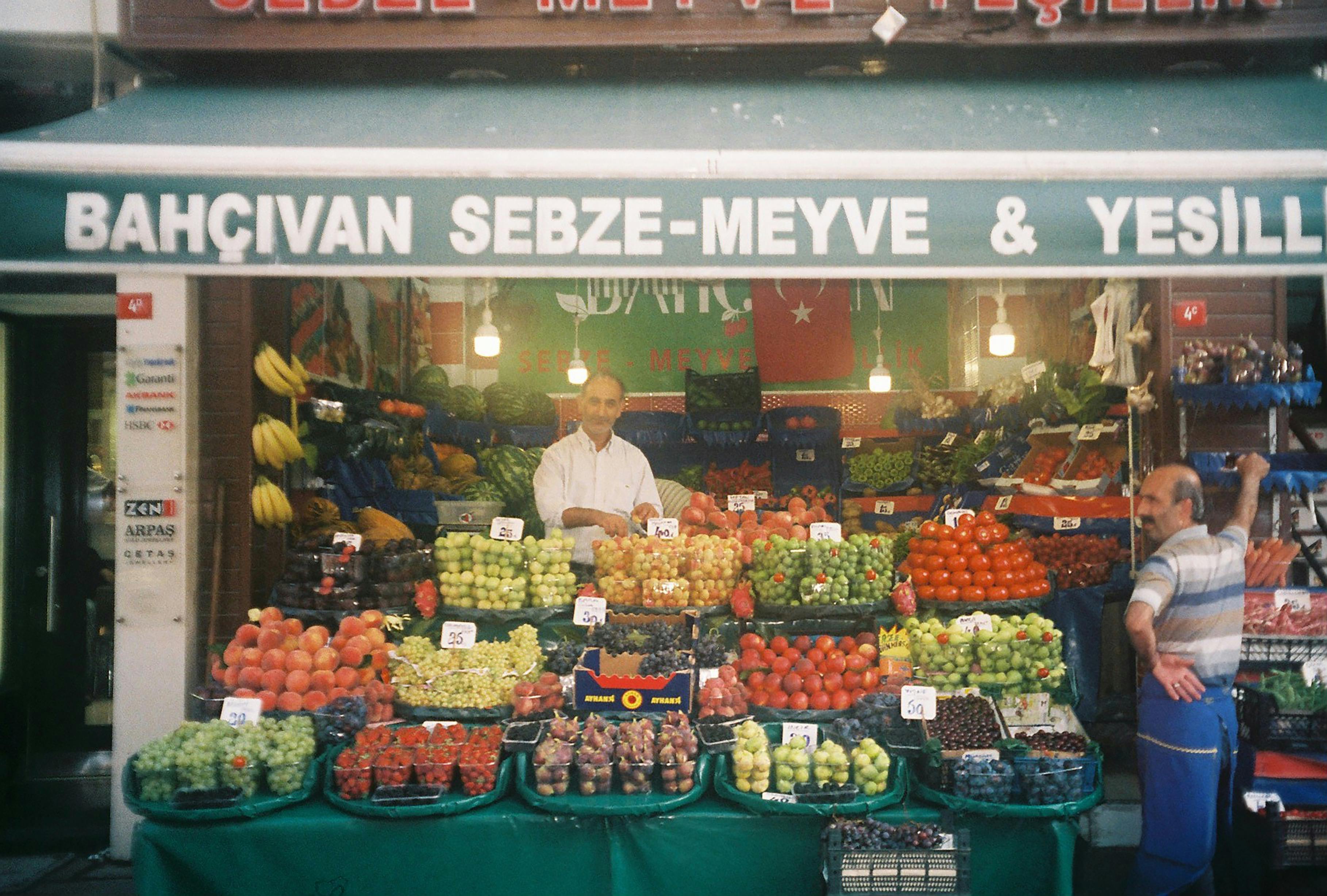 men standing on the fruit stall