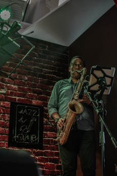Musician playing saxophone on stage at a Santo Domingo jazz club.