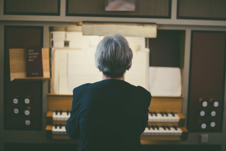 Back View Of Woman Playing Organ